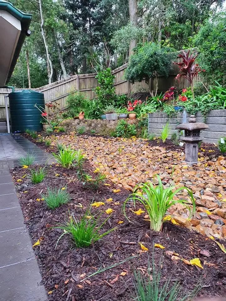 Dry creek bed with river stones and layered native planting