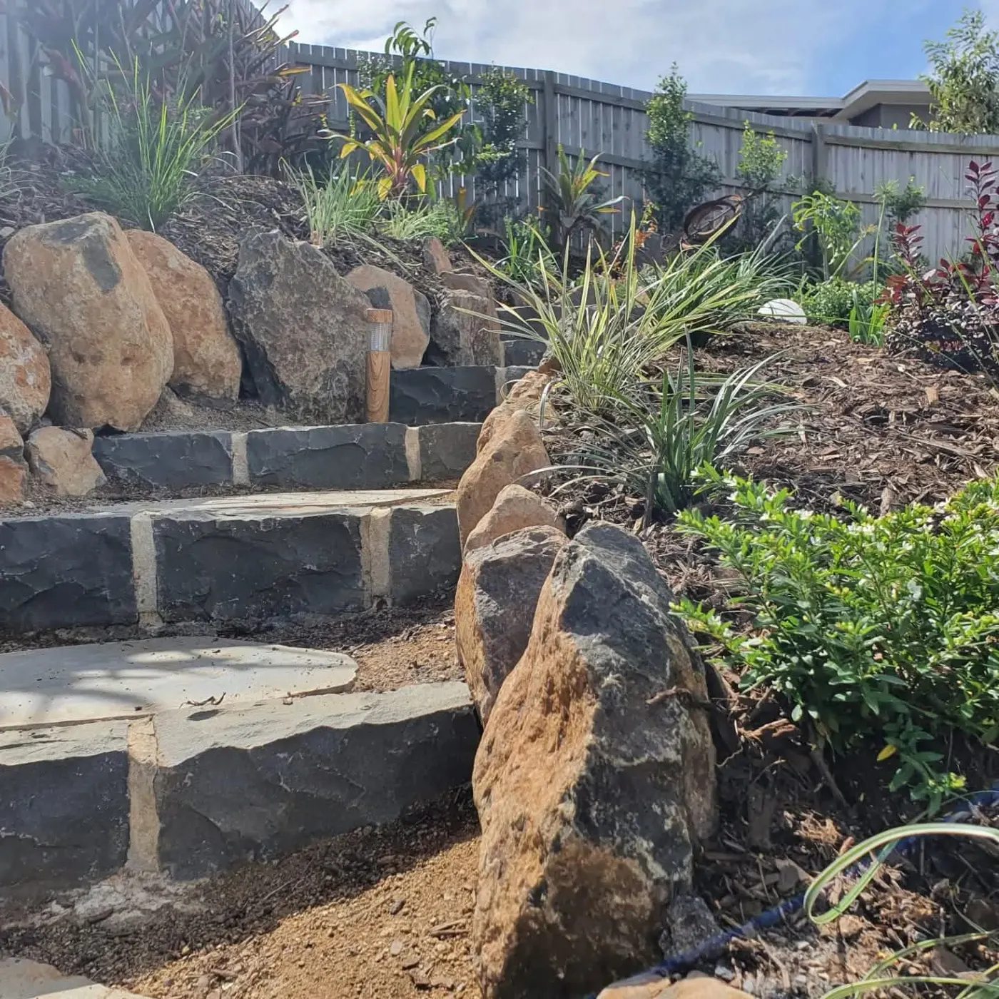 Natural stone stairs beside pond